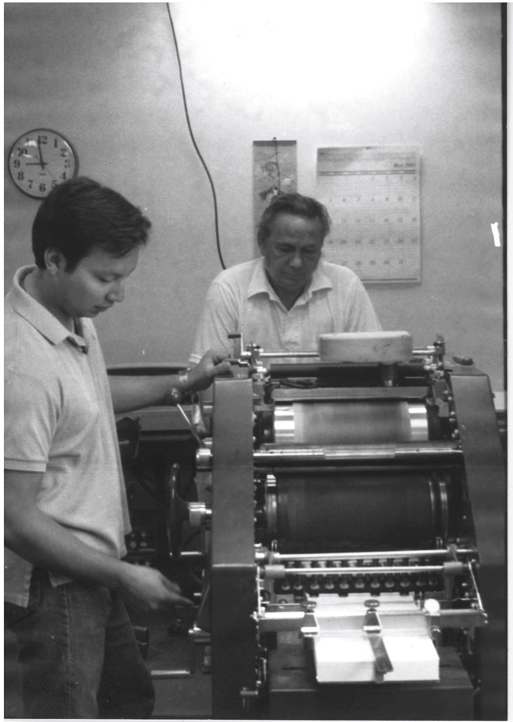 PUCT staff members manning a mimeograph in the days before Microsoft Word and laser printers.