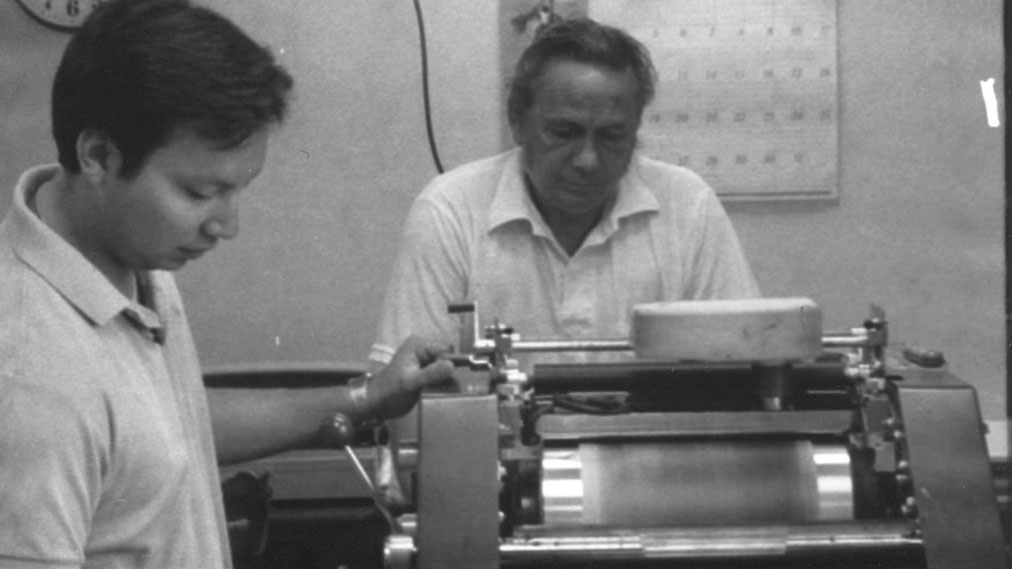 PUCT staff members manning a mimeograph in the days before Microsoft Word and laser printers.