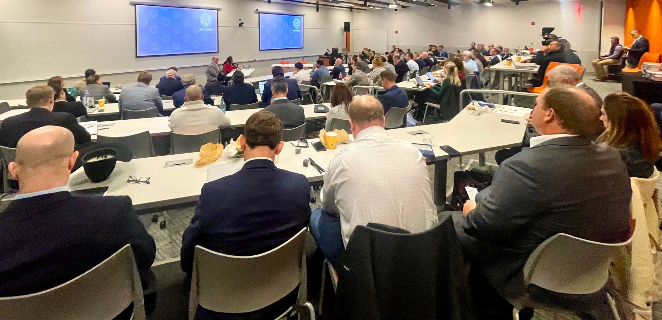 Commissioner Lori Cobos (red suit in front of audience) and PUCT Office of Public Engagement staff host a packed Permian Basin Reliability Workshop on the campus of UT Permian Basin in Dec. 2023. The Texas oil and gas industry is driving economic and population growth in the region, driving up demand for power and the PUCT is leading the effort to get it to them.
