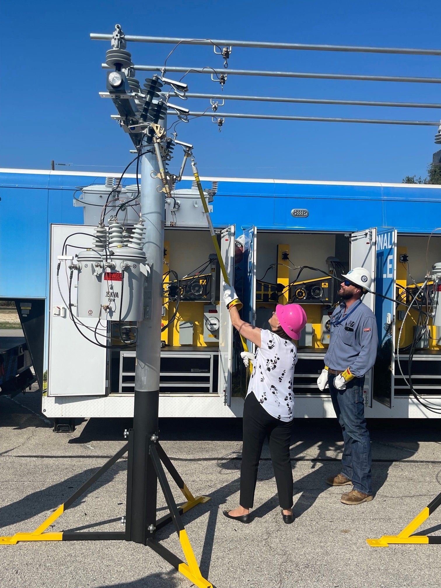 PUCT Commissioner Kathleen Jackson doing some hands-on learning about power line maintenance and repair at Pedernales Electric Coop.