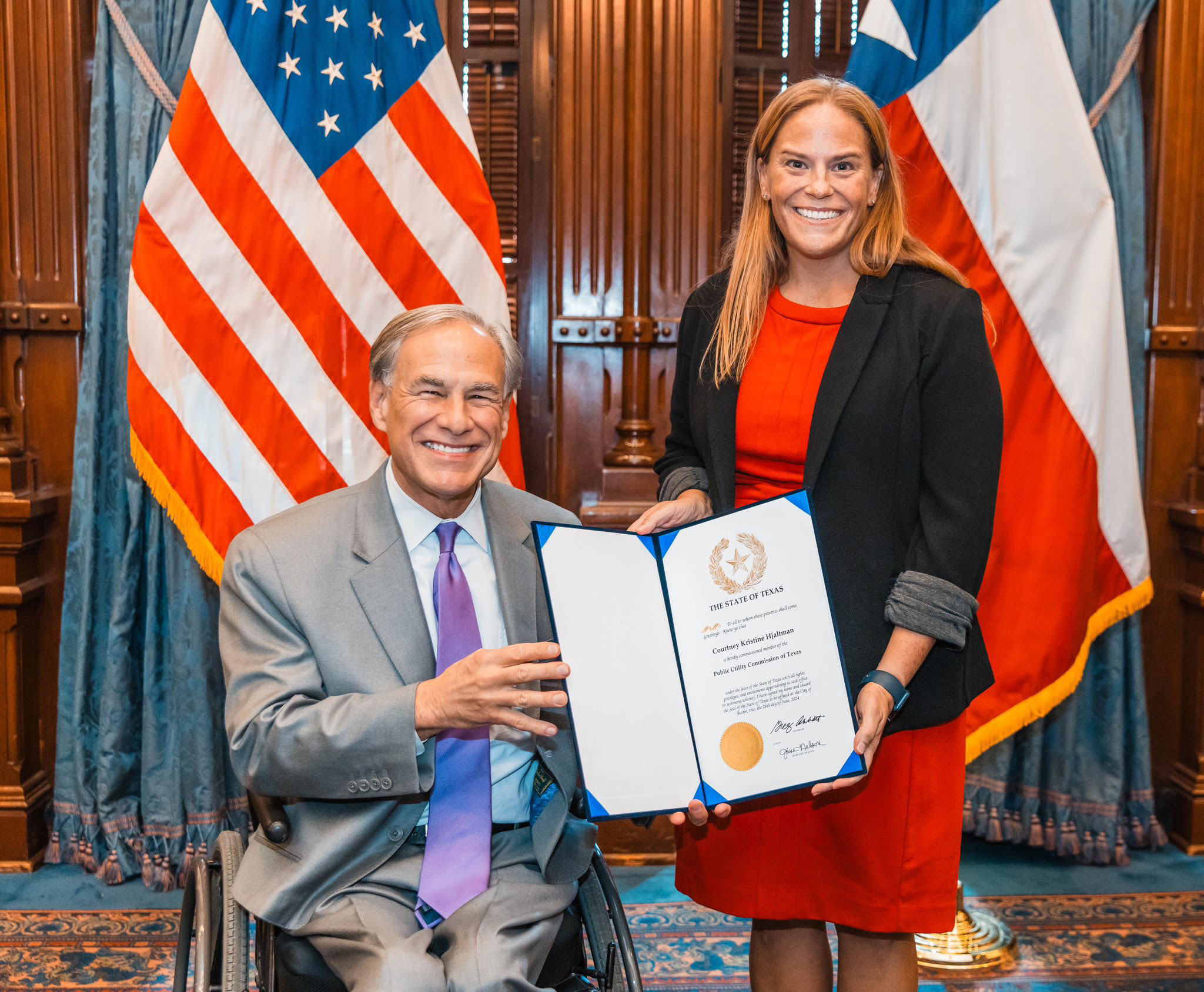 Gov. Greg Abbott congratulates Commissioner  Courtney Hjaltman following her swearing-in.