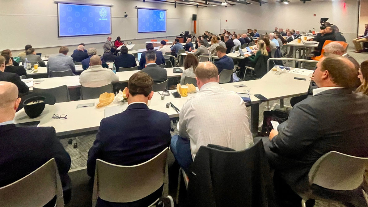 Commissioner Lori Cobos (red suit in front of audience) and PUCT Office of Public Engagement staff host a packed Permian Basin Reliability Workshop on the campus of UT Permian Basin in Dec. 2023. The Texas oil and gas industry is driving economic and population growth in the region, driving up demand for power and the PUCT is leading the effort to get it to them.