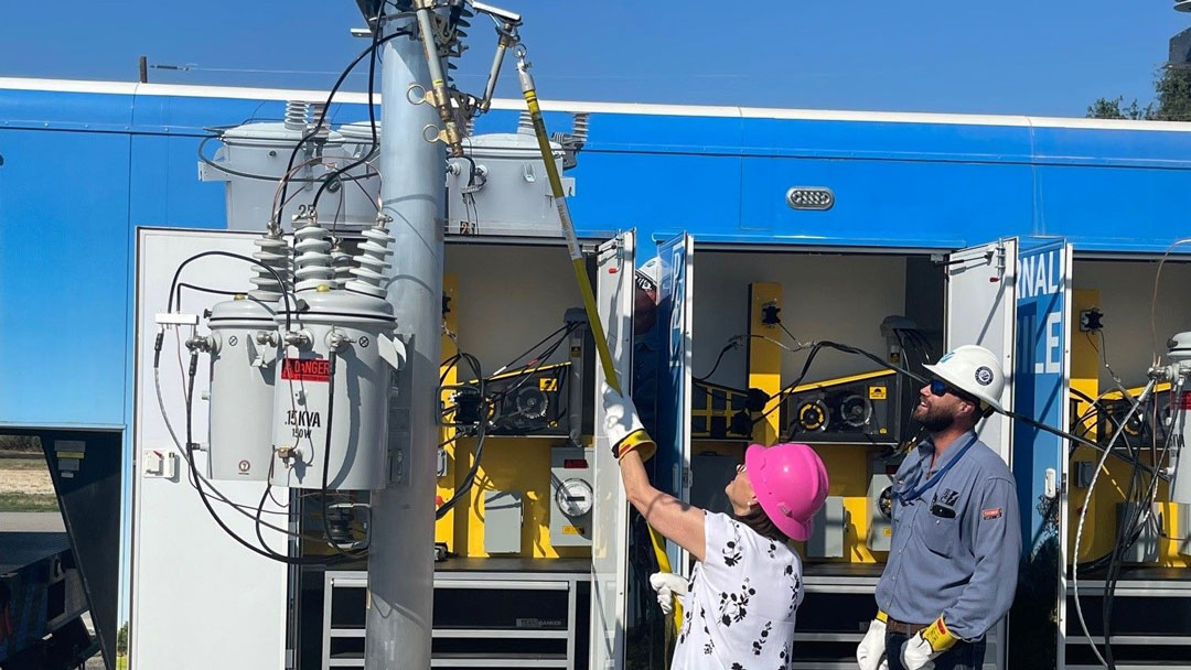 PUCT Commissioner Kathleen Jackson doing some hands-on learning about power line maintenance and repair at Pedernales Electric Coop.