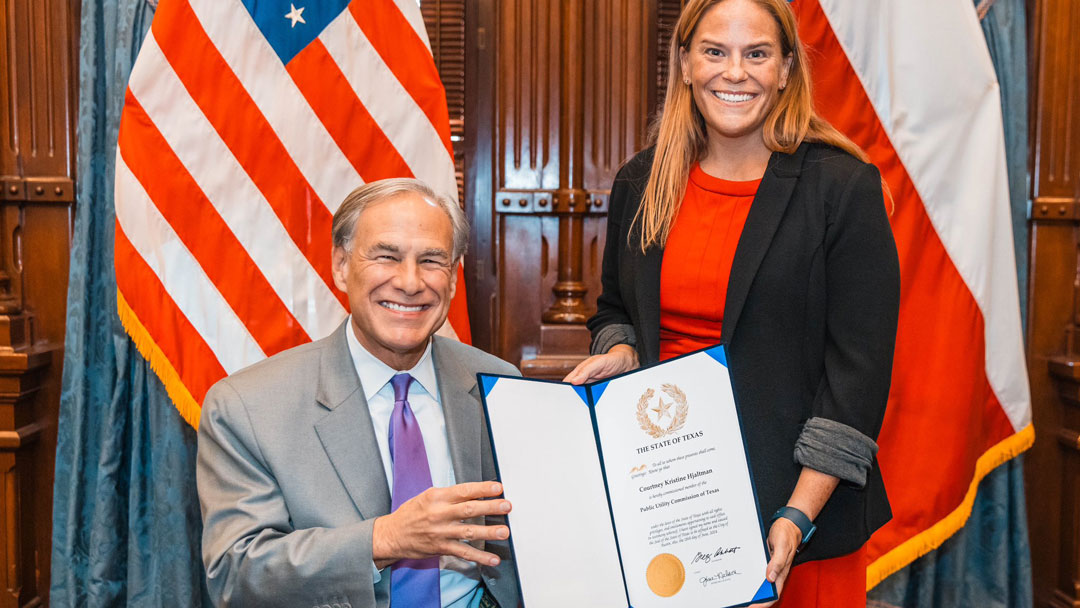 Gov. Greg Abbott congratulates Commissioner  Courtney Hjaltman following her swearing-in.