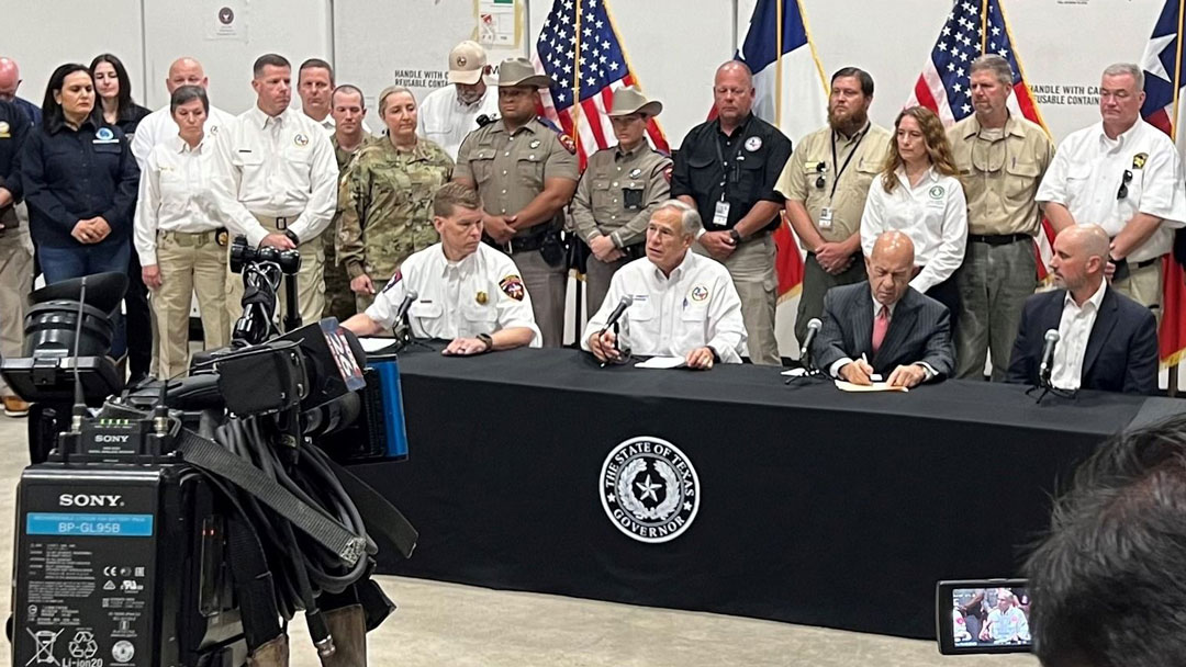 PUCT Chairman Thomas Gleeson (far right, seated) and Commissioner Lori Cobos (far left, standing) join Gov. Greg Abbott and local and state leaders on Hurricane Beryl recovery in Houston.